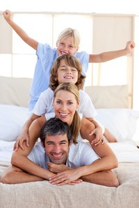 a family laying stacked on top of each other